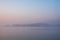 Beautiful landcape image of Spring sunrise over reservoir lake with dawn glow spreading aross the water with low mist adding