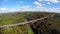 Beautiful landscape above old steel railroad train bridge aerial