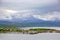 Beautiful landscape along with waters edge, with a village & church & mountains in the background, Saltstraumen, Bodo, Norway.