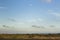 Beautiful landscape with a blue sky and a tiny, clear moon on wadden sea island Texel in the Netherlands