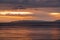 Beautiful landscape. Bright golden sunset with dramatics clouds over the lake after rain.