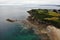 Beautiful landscape of Brittany in France, with green cliffs, trees, and houses