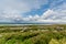 Beautiful landscape of the coast with limestone rocks with grass next to the Fanore beach