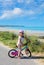 beautiful landscape of the coast in northern France with a little girl riding a bicycle on the dike