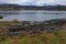 Beautiful landscape of the coast of Norway with misty snow-covered mountains on the background