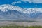 Beautiful landscape with fields of delta of Indus River, Tibetian buildings, Himalayas snow mountains, and blue sky,  in Ladakh,