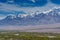 Beautiful landscape with fields of delta of Indus River, Tibetian buildings, Himalayas snow mountains, and blue sky,  in Ladakh,