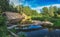 Beautiful landscape of forest river with bridge and reflections of clouds and trees.