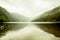 Beautiful landscape from the heart of Glendalough valley in a foggy day, with mountains reflecting in the Lower lake, Ireland.