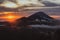 Beautiful landscape with high mountains grey sky and orange sunlight in sunrise