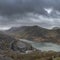 Beautiful landscape image of Dinorwig Slate Mine and snowcapped Snowdon mountain in background during Winter in Snowdonia with