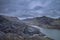Beautiful landscape image of Dinorwig Slate Mine and snowcapped Snowdon mountain in background during Winter in Snowdonia with