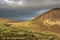 Beautiful landscape image in the English Lake District with glorious Summer sunset light dappled acros the hills