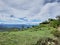 Beautiful landscape image of mountains half covered by clouds with the background of blue sky