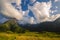 Beautiful landscape mountain green field grass meadow white cloud blue sky on sunny day. Majestic green scenery big mountain hill