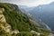 A beautiful landscape of mountains with bushes, rocks and a blue river on a summer day at sunset. Sulak Canyon