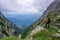 Beautiful landscape in the mountains and woman climber admiring the view