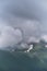 Beautiful landscape of National Park of Russia. Dark thundercloud envelops snowy mountain peak. Forest and mountains in fog in