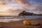 Beautiful landscape of the old town of Peniscola with the castle on the top and the sea waves on the beach in the foreground at