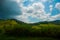 Beautiful landscape overlooking fields and hills with white clouds and blue sky. Brazil