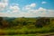 Beautiful landscape overlooking fields and hills with white clouds and blue sky. Brazil