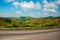 Beautiful landscape overlooking fields and hills with white clouds and blue sky. Brazil