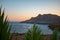 Beautiful landscape with palm leaves, sea and mountains on sunset. Tripiti beach