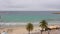 Beautiful landscape palm trees on sea coast and water waves on sandy beach seafront