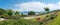 Beautiful landscape park with wooden bench, tourist resort Gstadt, lake chiemsee and alps in the back