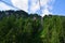 Beautiful landscape with pine trees and cable car up to Hahnenkamm ski run on Kitzbuhel
