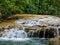 Beautiful landscape with a pretty little waterfall on the Bresque river surrounded by green vegetation in Sillans-la-cascade