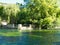 Beautiful landscape of Provence with the water of the Sorgue river at Fontaine de Vaucluse and the verdant trees of spring