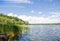 Beautiful landscape of reeds, lake and blue sky, summer day.