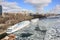 Beautiful landscape river covered by ice and standing large ships at berth