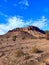 Beautiful landscape of a rocky mountain raising above a desert on a sunny day