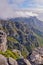 Beautiful landscape of rocky mountains with a cloudy blue sky on a summer day. Peaceful and scenic view of a peak with