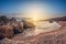 Beautiful landscape, sandy rocky bay at sunset, wild seashell beach