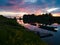 Beautiful landscape of the Sava river with reflection during sunset, Fishing boats moored to wooden docks