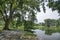 Beautiful landscape scene at the quiet green foliage lake.