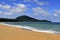 Beautiful landscape of sea with sand, wave, blue sky and mountain background at Mai Khao beach Phuket, Thailand Beauty in nature.