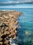 Beautiful landscape of sharp cliffs and rocks and calm ocean water