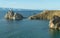 Beautiful landscape of Siberian Baikal Lake. larch in the foreground. Panoramic view of Shamanka Rock on Olkhon
