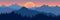 Beautiful landscape. Silhouette of dark blue forest on background of mountains and sunset. Panoramic view. Vector illustration