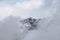 Beautiful landscape of snow lofty Austrian Mountain in clouds