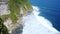 Beautiful landscape of stone cliffs, ocean waves and oceanscape. Aerial top view. Bali, Indonesia. slow motion