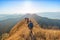 Beautiful landscape with trekkers walking on mountain ridge in sunset at Thong Pha Phum National Park Kanchanaburi of Thailand