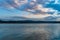 Beautiful landscape with turquoise lake, reflection of blue sky and wild mountains. Relaxing paradise background. Tranquility.