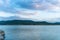 Beautiful landscape with turquoise lake, reflection of blue sky and wild mountains. Relaxing paradise background. Tranquility.