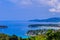 Beautiful landscape of turquoise ocean waves with boats, coastline and blue sky background from high aerial view point