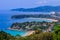 Beautiful landscape of turquoise ocean waves with boats, coastline and blue sky background from high aerial view point